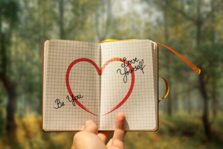 a hand and a notebook with note